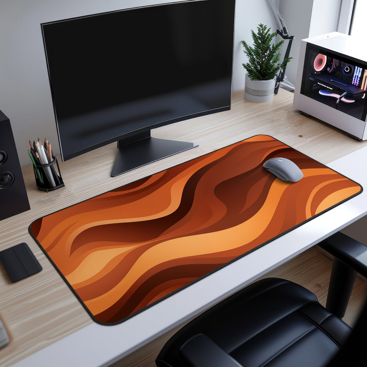 Abstract Wavy Desk Mat in orange waves on wooden desk, high-angle view under monitor with mouse, plant and PC.