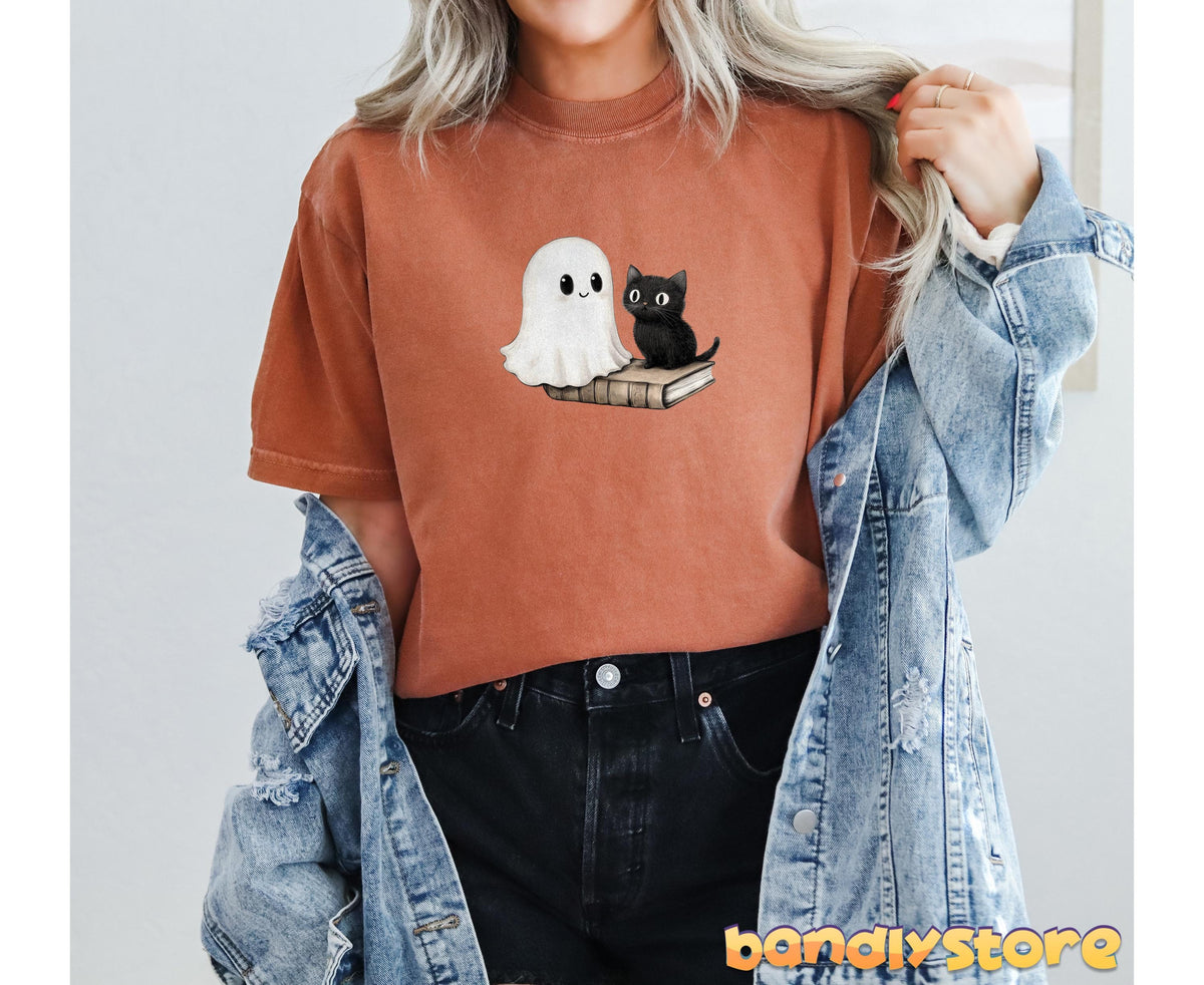 Cute Bookish Ghost T-Shirt in yam on a person facing forward with open denim jacket and black jeans by a plain wall.