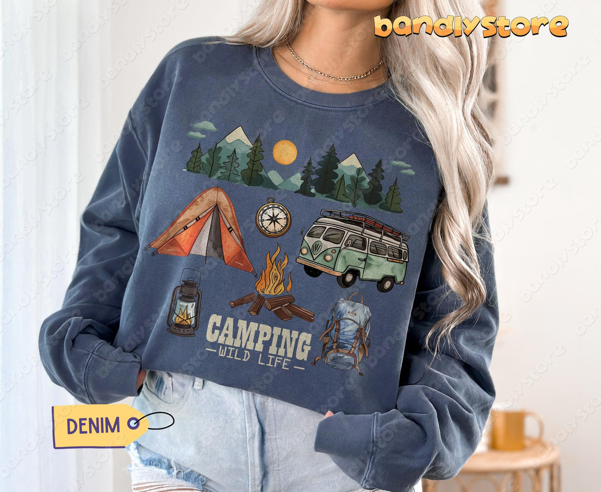 Camping Wildlife Sweatshirt in denim front-facing on wearer with hands in pockets indoors by curtains.