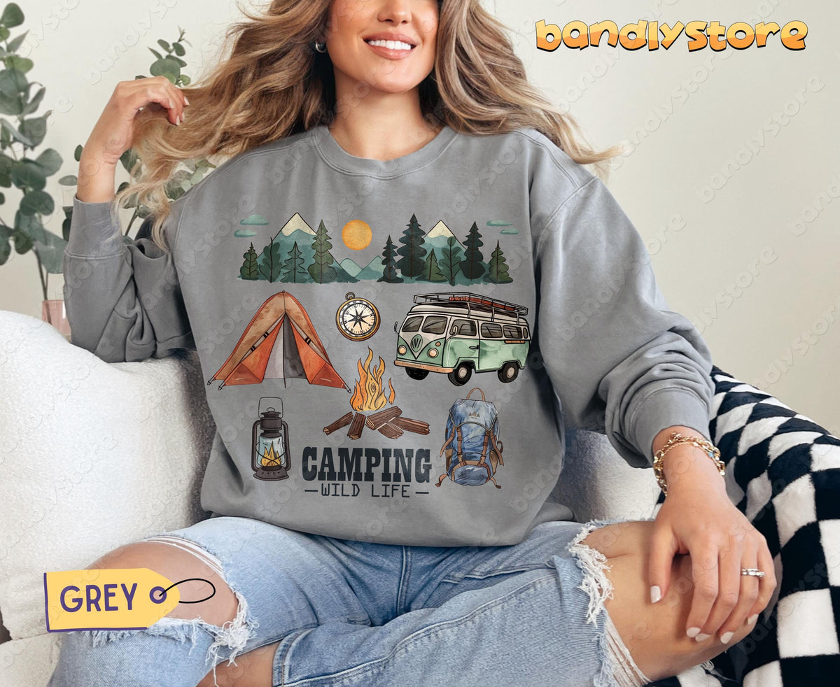 Camping Wildlife Sweatshirt grey front view on seated model with plant and checkered blanket nearby.