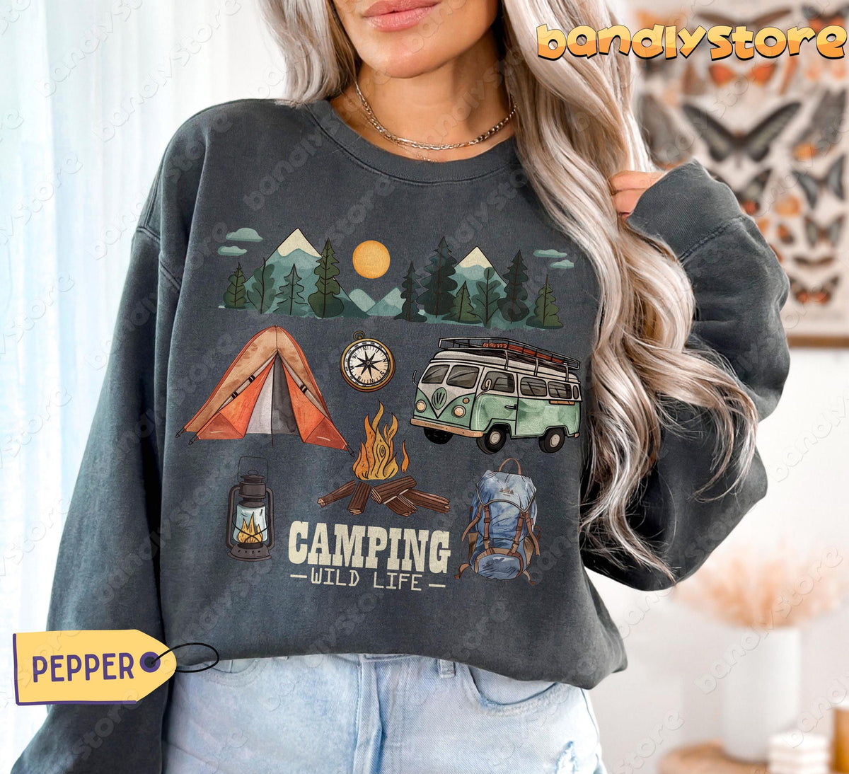 Camping Wildlife Sweatshirt in pepper on model, front view with tent, bus, campfire, mountains indoors.