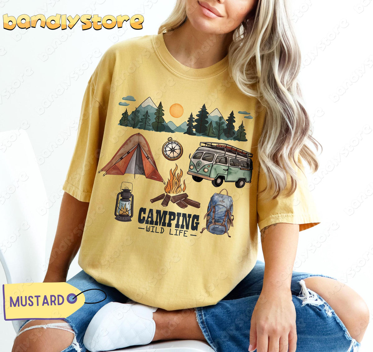 Happy Camper T-Shirt in mustard on a seated model showing tent, van, campfire, backpack and mountain graphics.