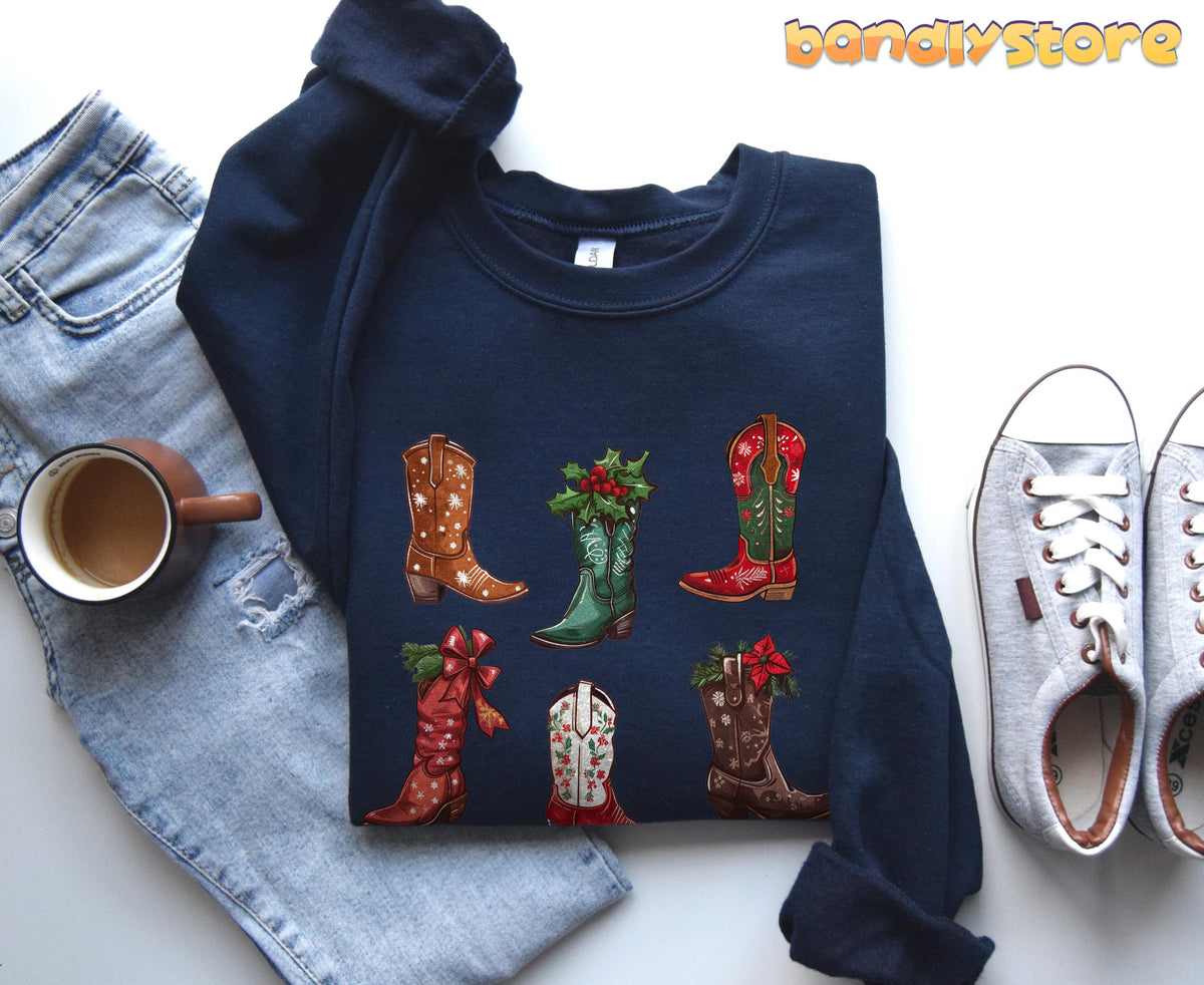 Christmas Cowgirl Boots Sweatshirt in navy, flat-laid with jeans, coffee mug and grey sneakers.