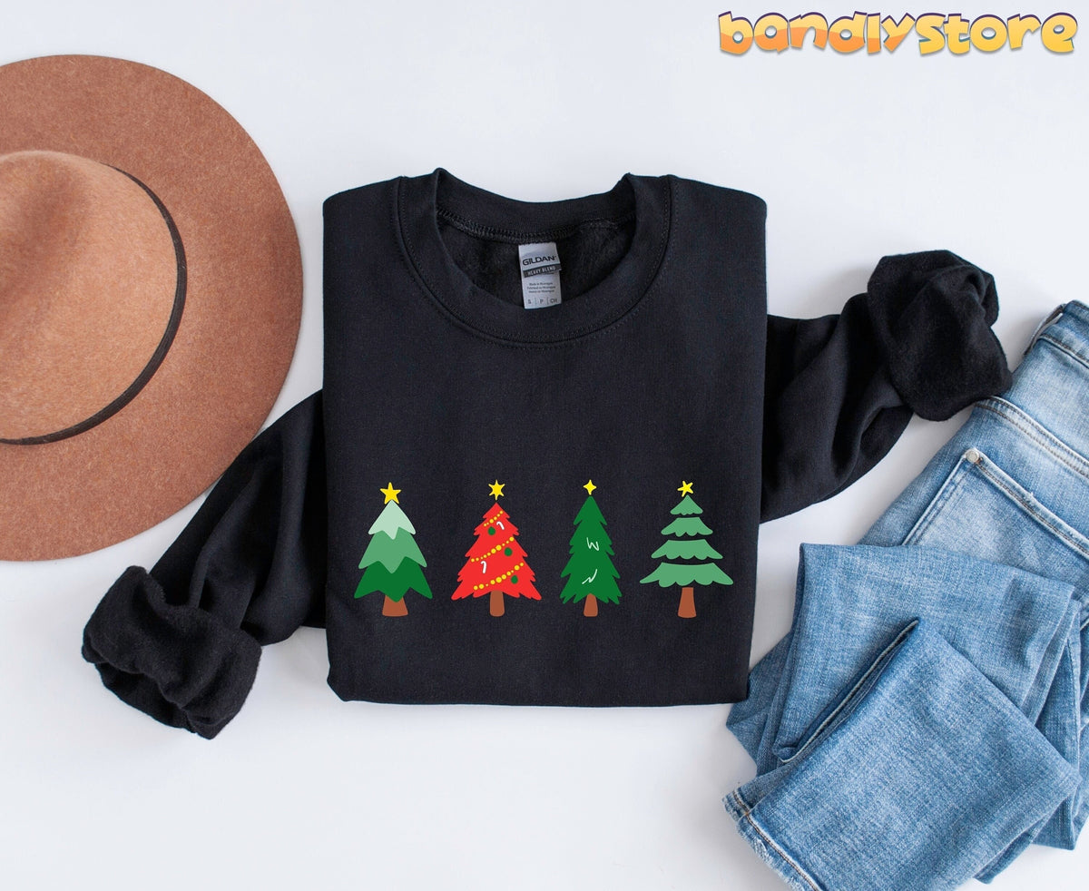 Oh Christmas Tree Sweatshirt black folded flat beside a brown hat and blue jeans.