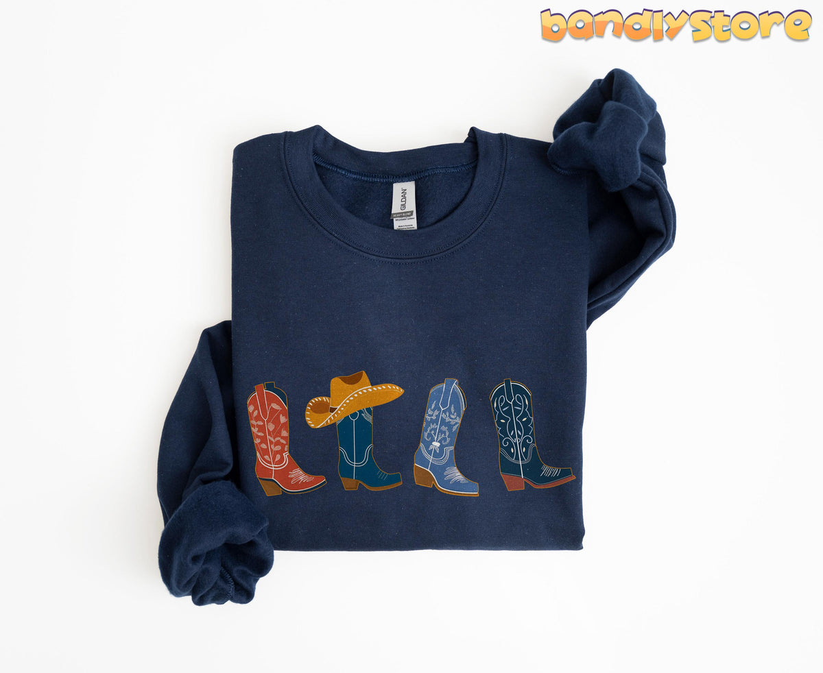Cowgirl Boots Sweatshirt navy folded flat on white background with four cowboy boots across front.