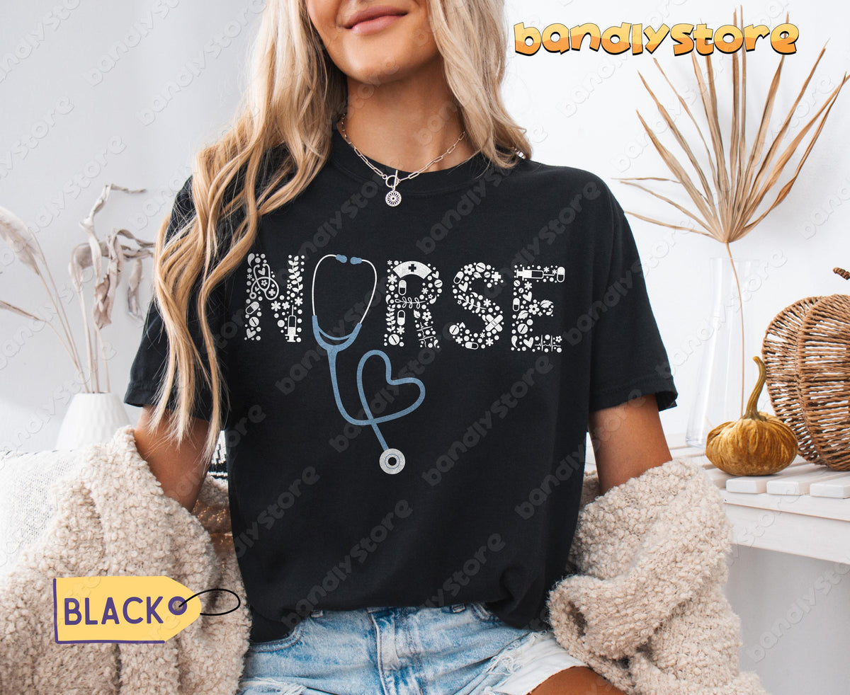 Custom Name Nurse T-Shirt in black on a seated woman indoors beside dried plants and a pumpkin.