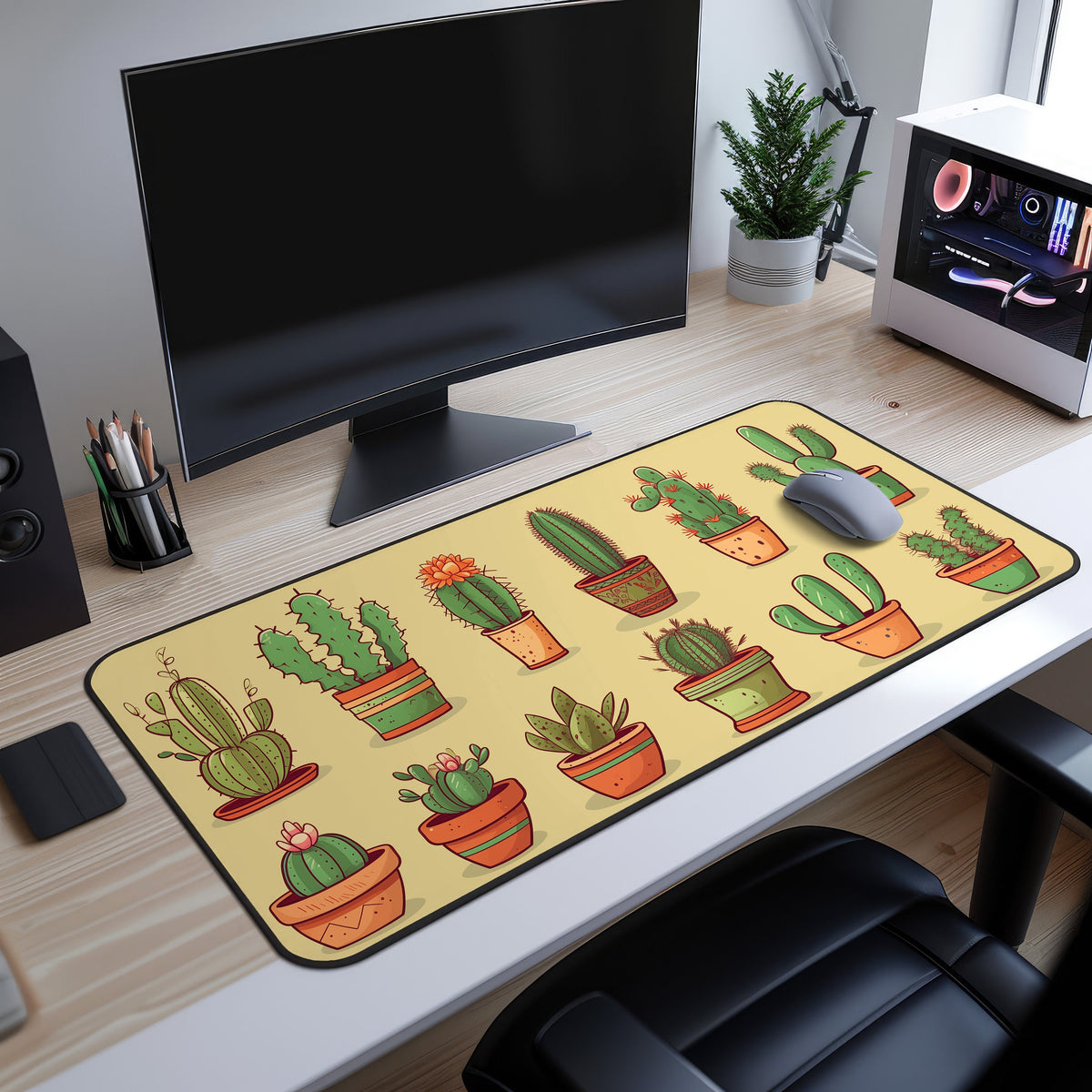 Cute Cactuses Desk Mat on a light wood desk under a black monitor, grey mouse atop it beside a plant and white PC.