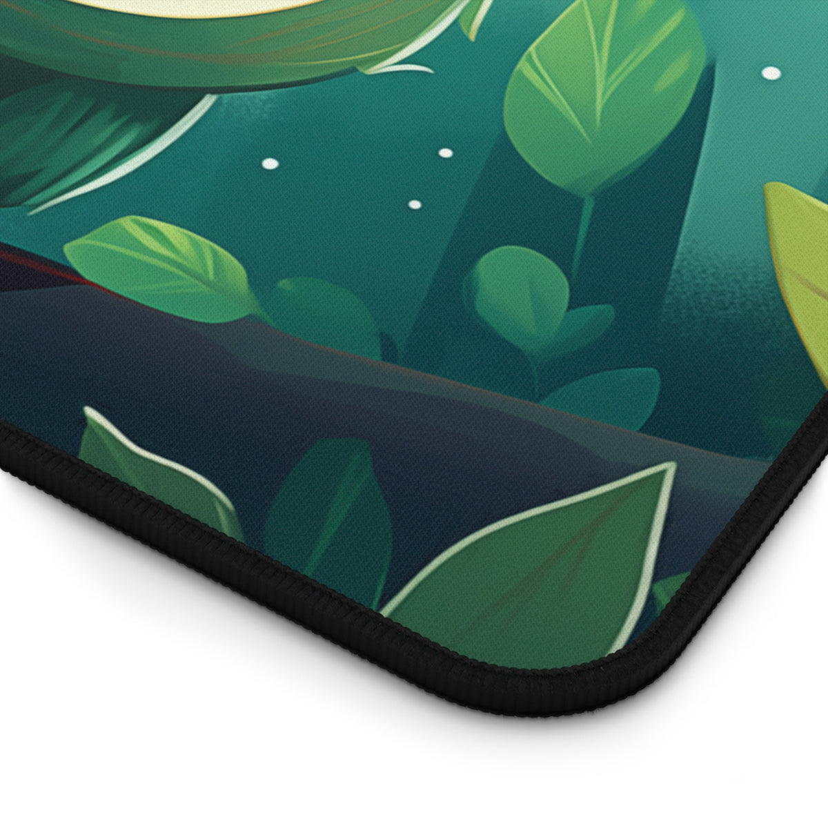 Cute Owl Desk Mat corner detail showing green leaves on teal fabric with black stitched edge.
