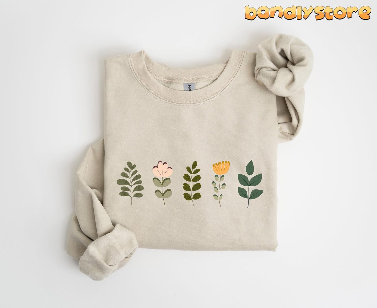 Cute Wildflowers Sweatshirt in sand folded flat on a plain white background.