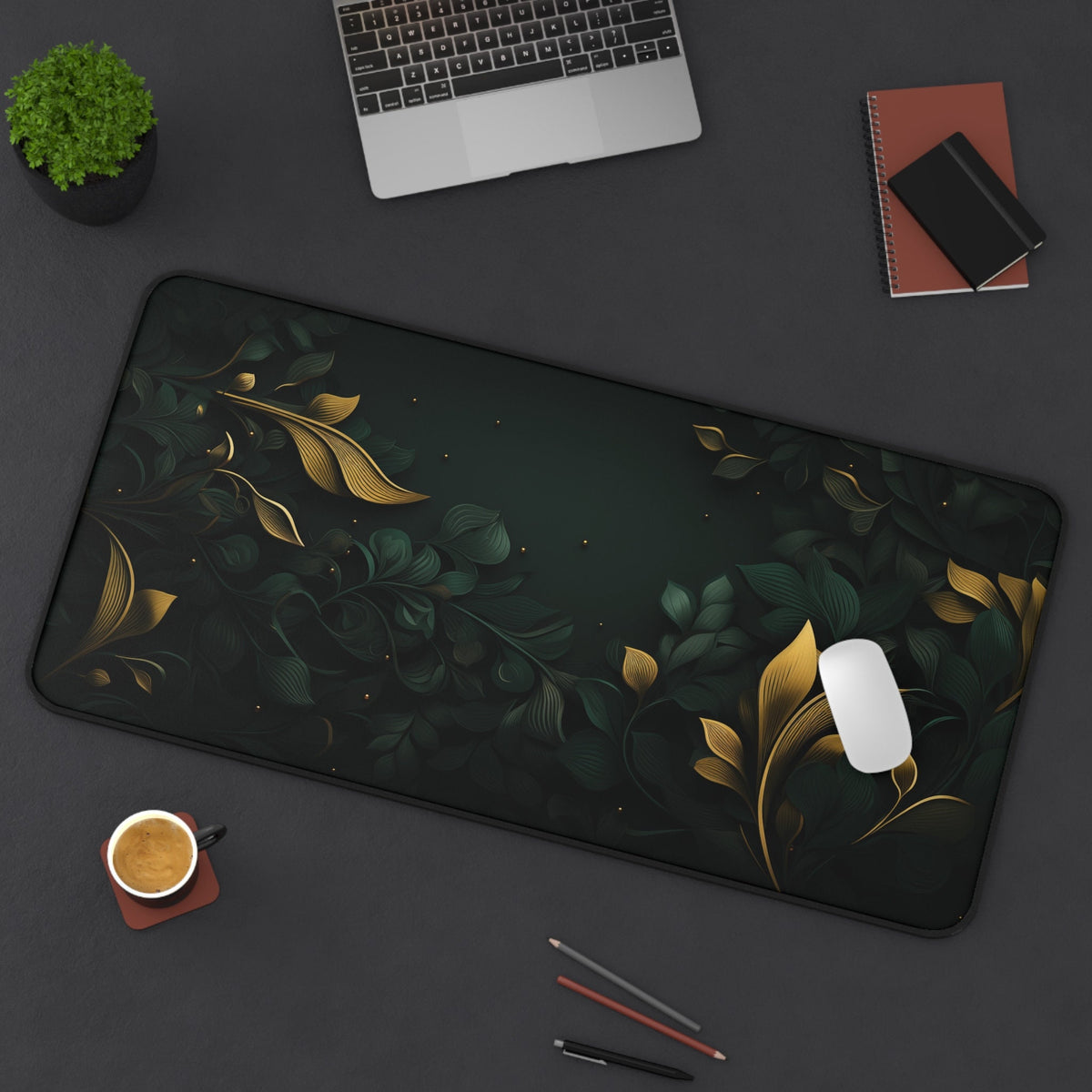Botanical Leaves Desk Mat 16 × 32 inches top-down on a desk with laptop, plant, coffee, notebooks and mouse.