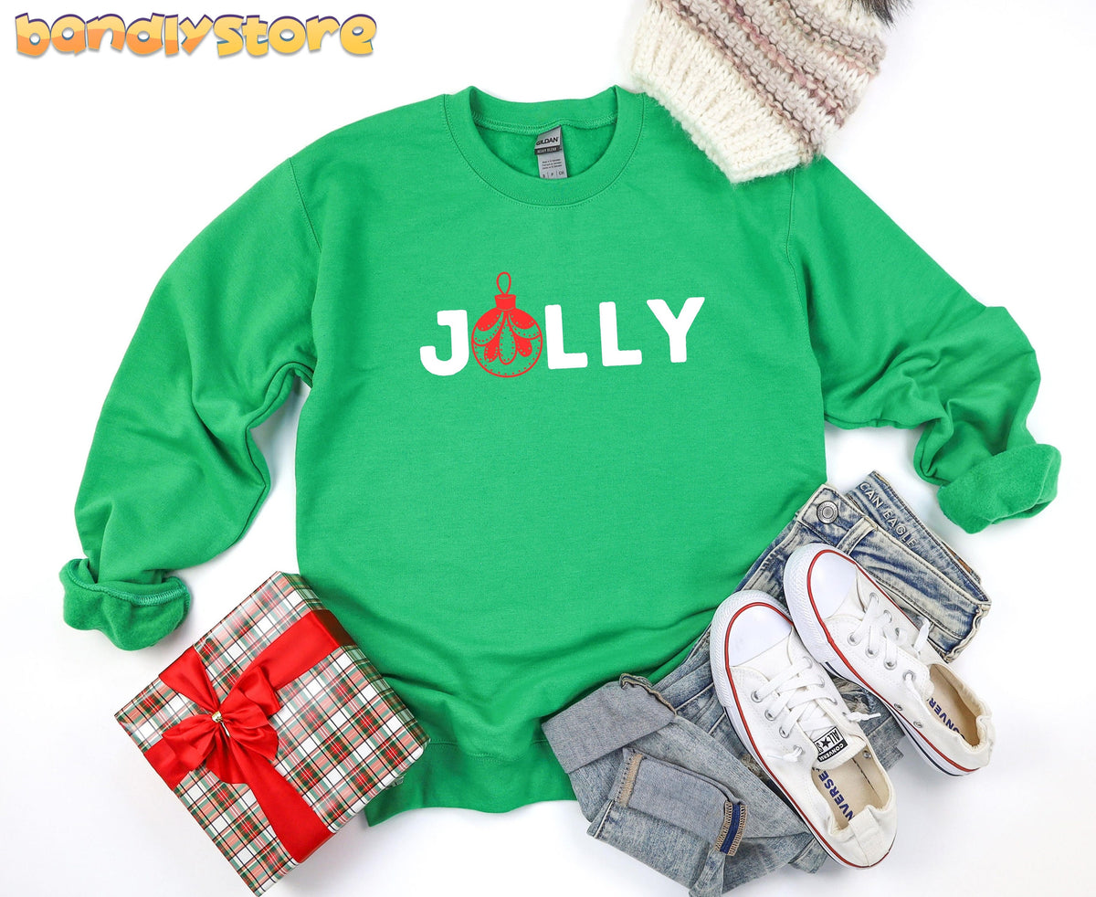Feeling Jolly Christmas Sweatshirt in Irish Green, flat-lay with beanie, plaid gift, jeans and sneakers.