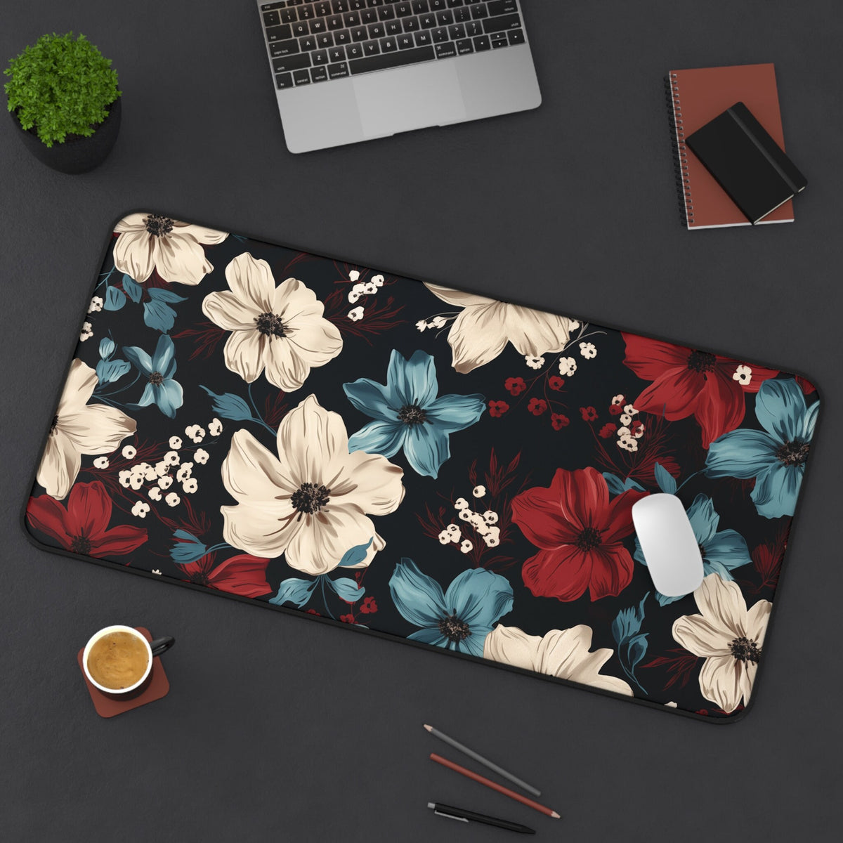 Dark Floral Desk Mat on a dark desk with laptop, plant, coffee, notebooks, pens and mouse; 16×32 inches, 16 × 32 inches