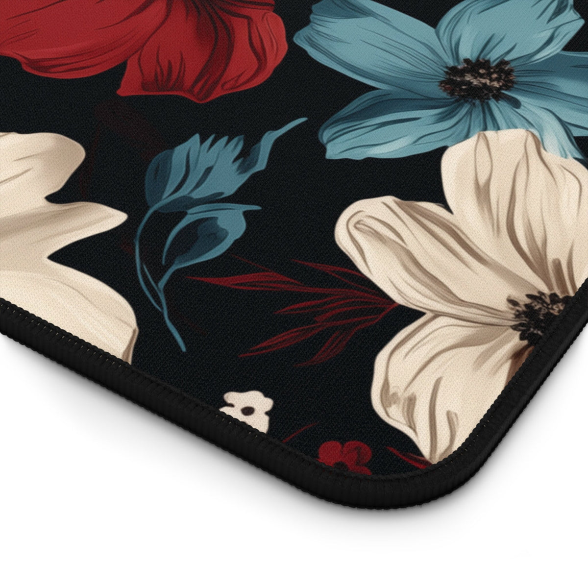 Dark Floral Desk Mat detail close-up of the rounded corner with stitched edge on a plain white background.