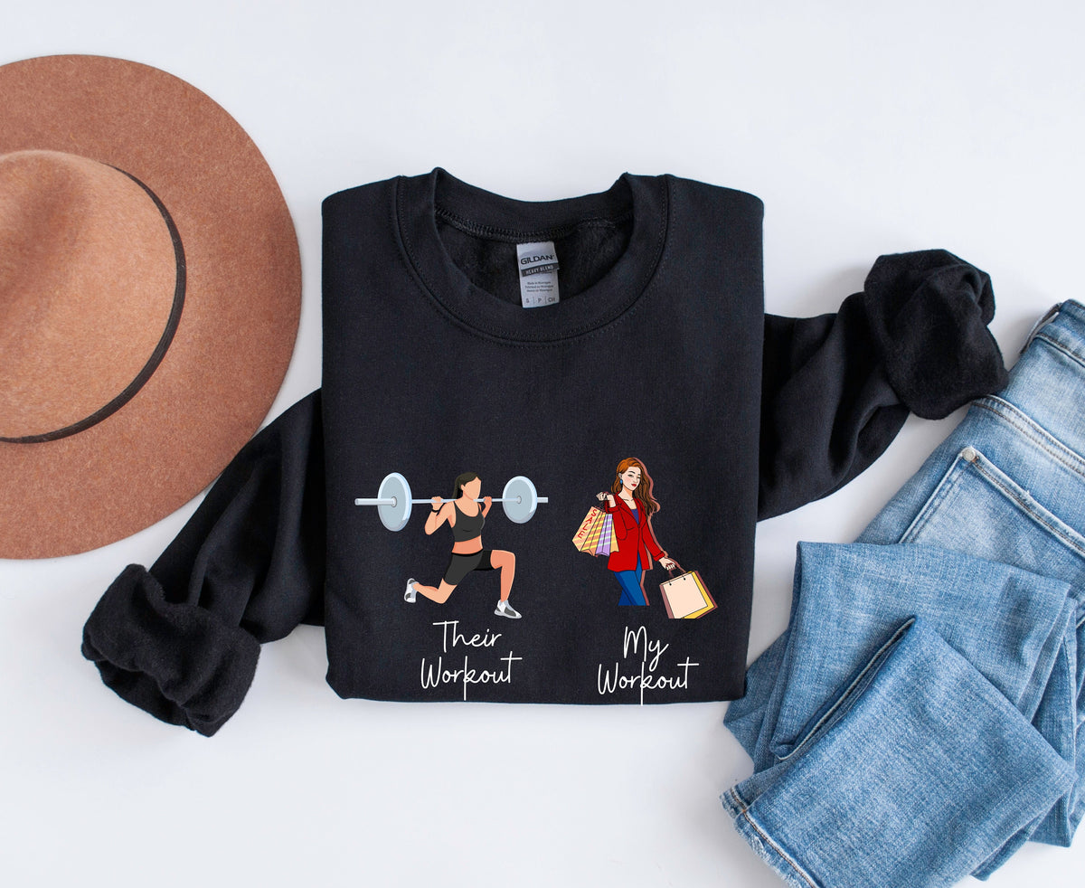 Funny Fitness Sweatshirt on black fabric, flat-lay with hat left and jeans right, gym vs shopping graphics.