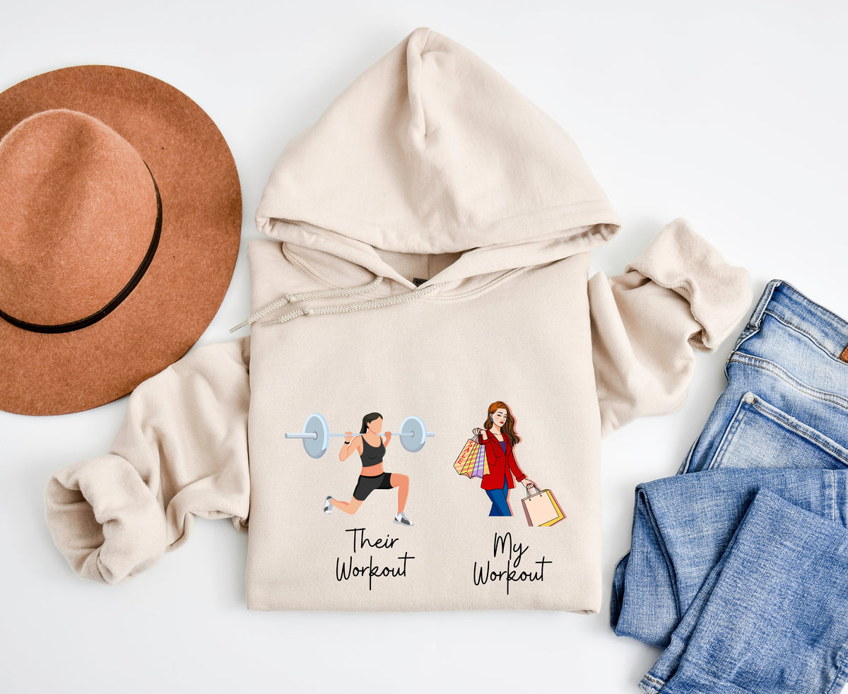 Funny Fitness Hoodie in sand laid flat overhead next to a brown hat and blue jeans.