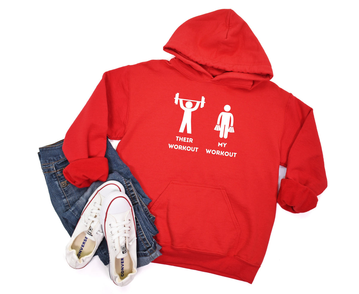 Funny Workout Hoodie in red flat-laid from above beside folded jeans and white sneakers.