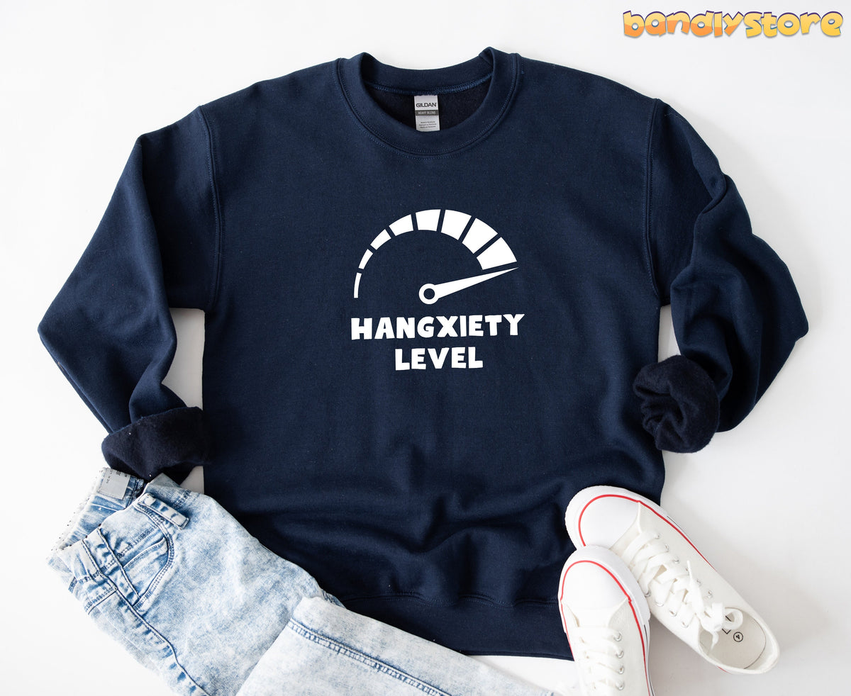 Hangxiety Hangover Sweatshirt in navy, flat-laid with light jeans left and white sneakers right.