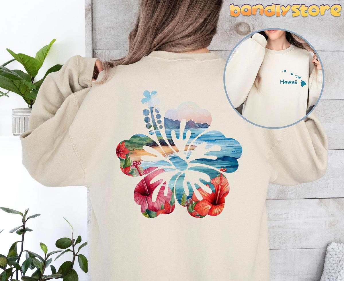 Hawaii Hibiscus Sweatshirt with Back Print in sand, back view next to plants against a wooden wall.