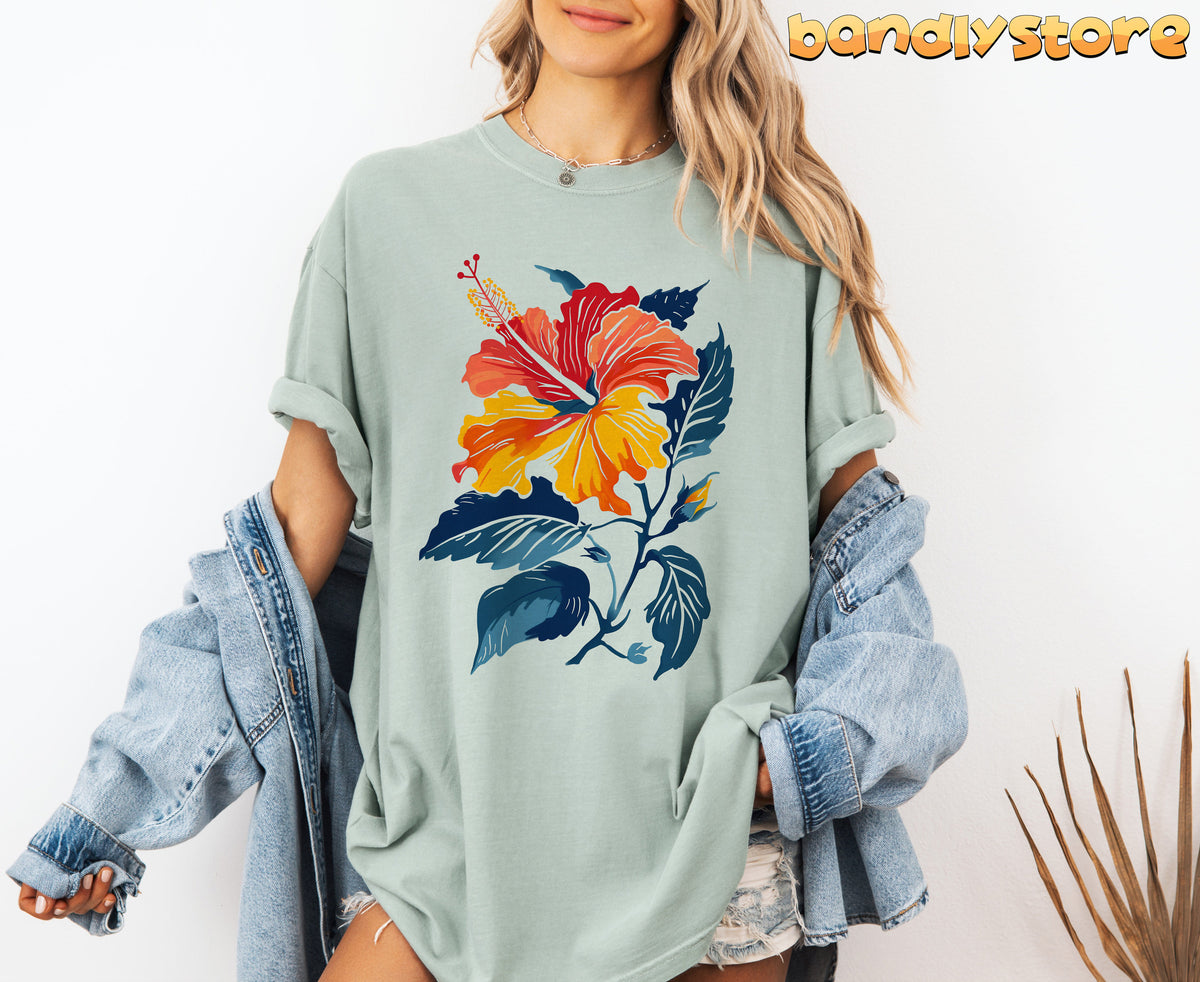 Hibiscus Flower T-Shirt on a model with denim jacket over shoulders, front view against white wall with dried plant.