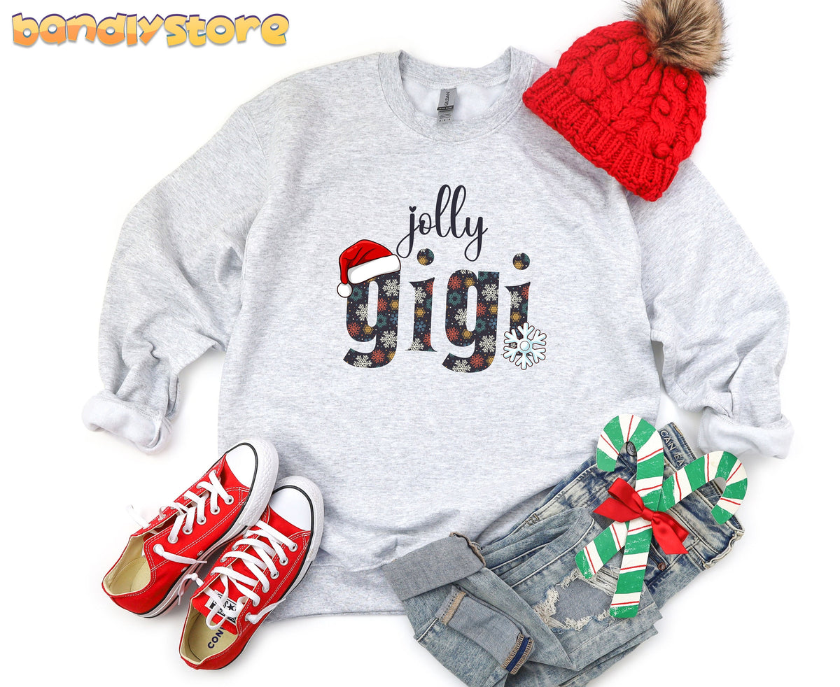 Jolly Gigi Sweatshirt in ash, laid flat with red beanie, sneakers, jeans and candy canes.