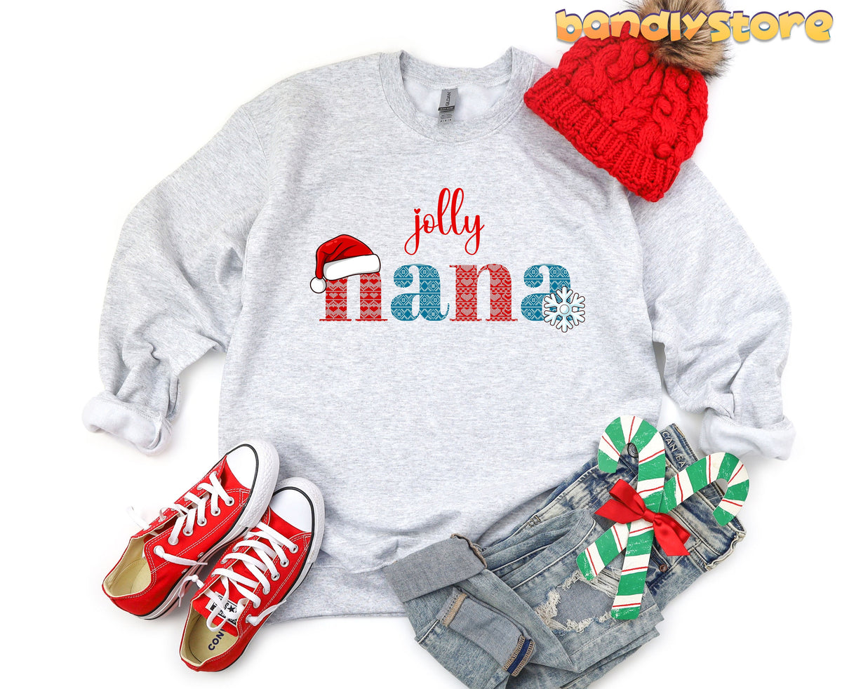 Jolly Nana Sweatshirt in ash laid flat from above beside a red beanie, sneakers, jeans and candy canes.