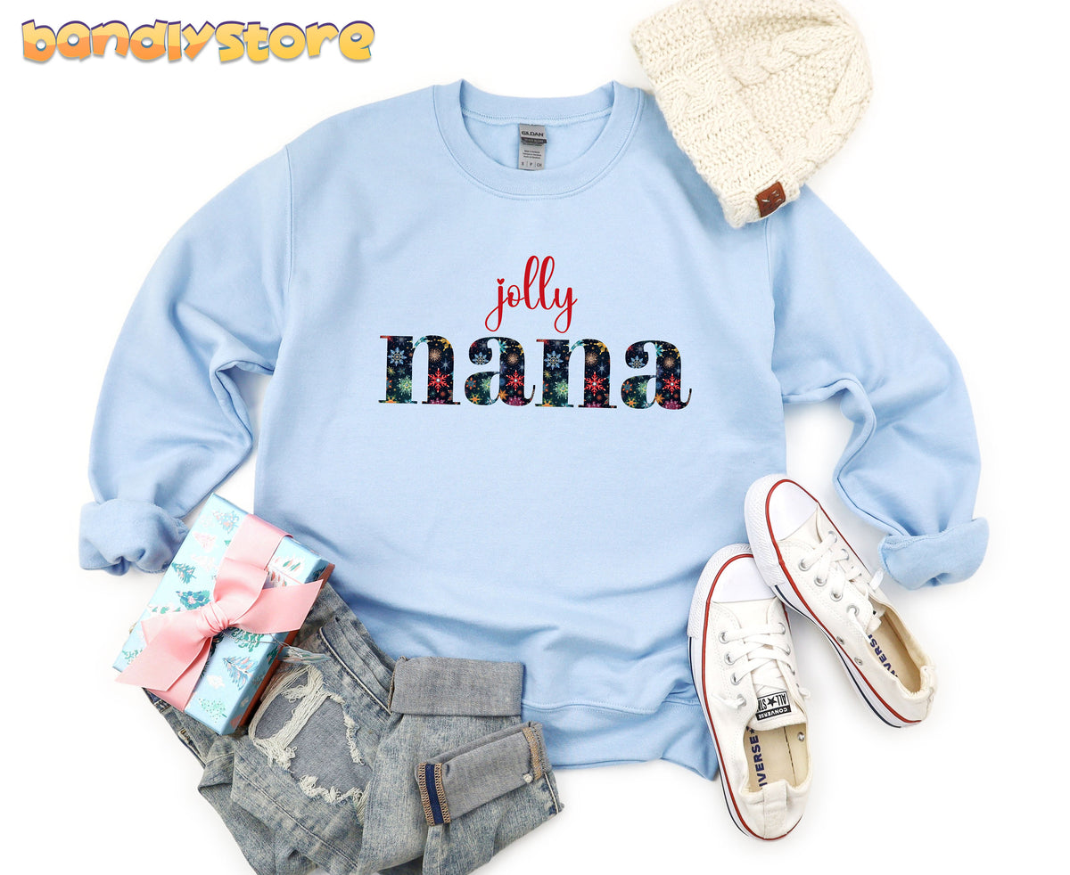 Jolly Nana Sweatshirt in light blue flat-laid from above with beanie, sneakers, jeans and gift box.