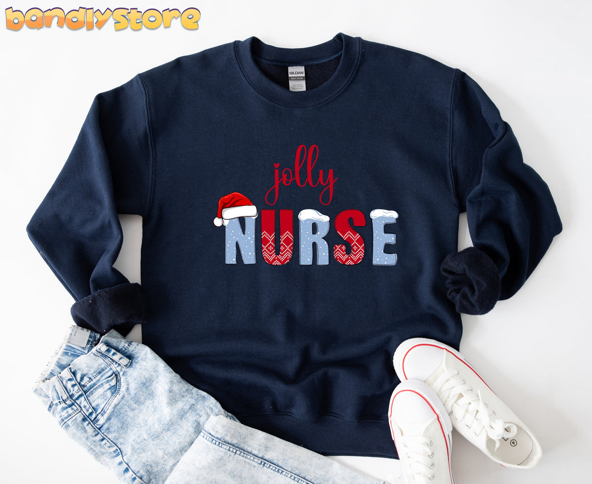 Jolly Nurse Sweatshirt in navy flat-laid on white beside light jeans and white sneakers.