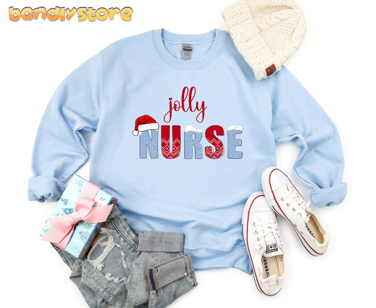 Jolly Nurse Sweatshirt in light blue flat-laid from above with beanie, sneakers, gift and jeans.