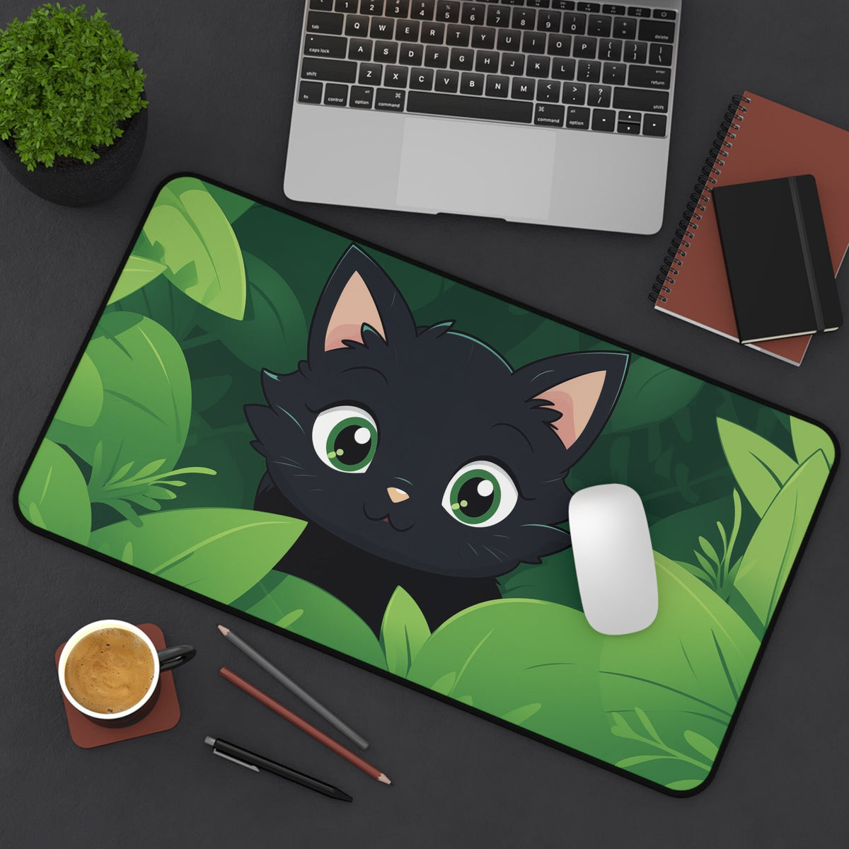 Cute Kawaii Black Cat Desk Mat 12 × 22 inches top-down on desk with laptop, plant, notebooks, mouse, cup, pencils.