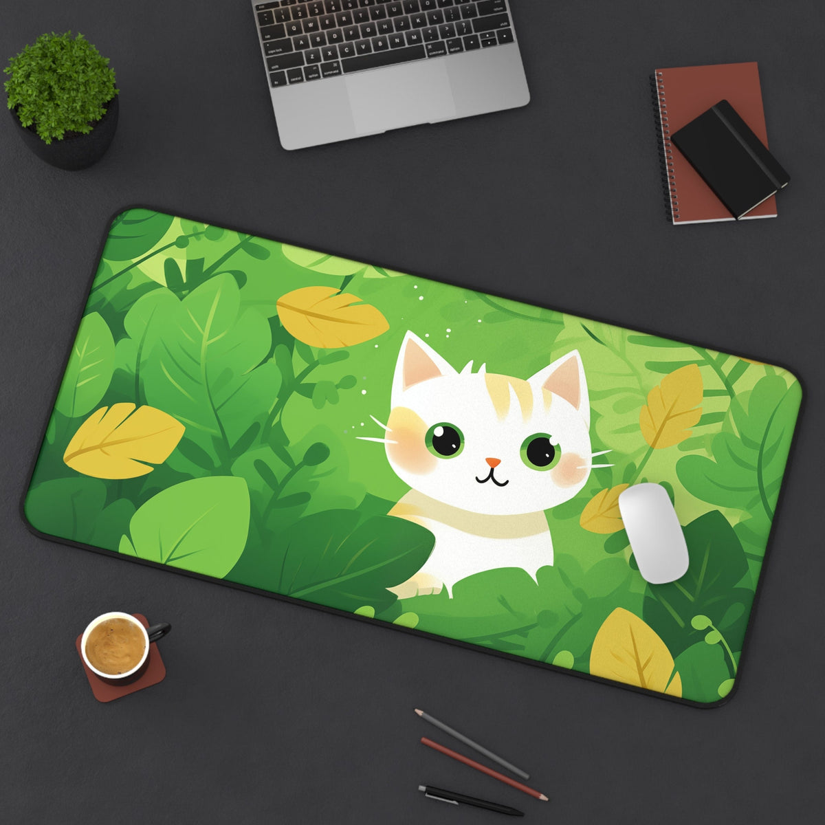 Cute Kawaii Cat Desk Mat in green leaf pattern on a dark desk with laptop, plant, coffee and mouse, 16 × 32 inches