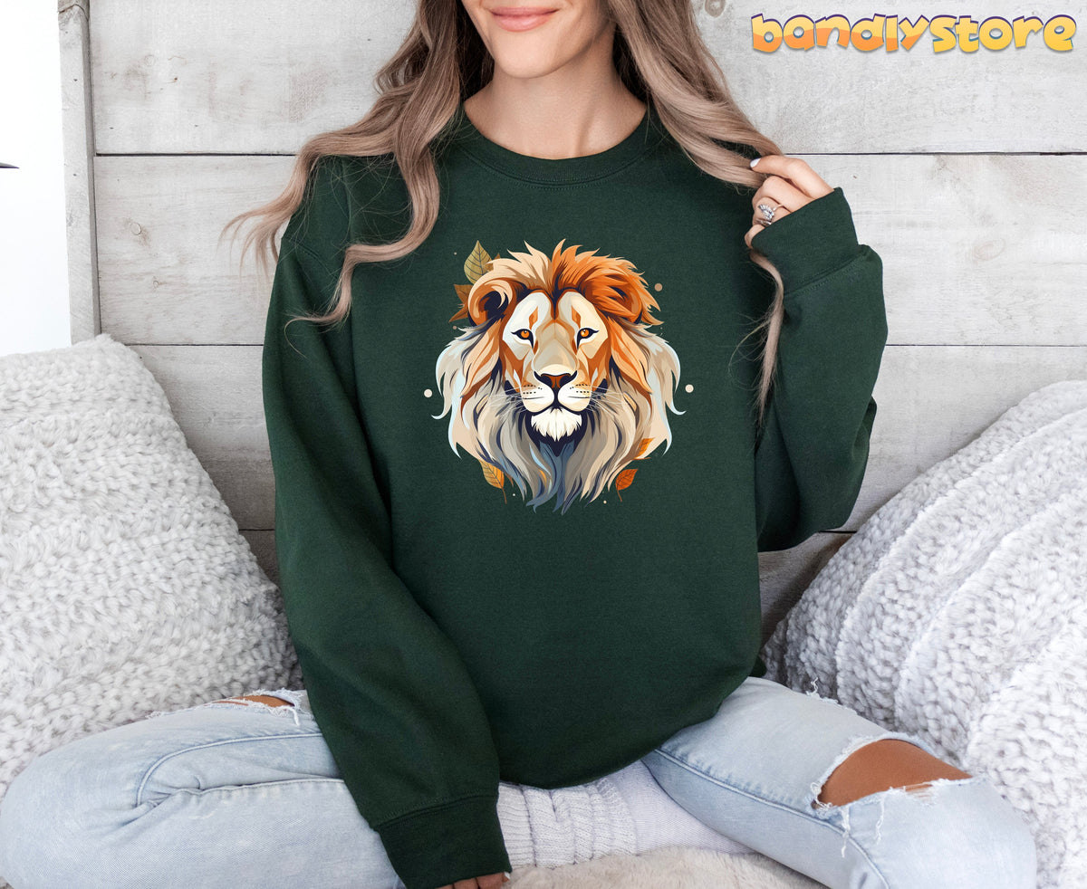 Majestic Lion Sweatshirt in forest green, worn front-facing by a seated model amid white pillows and wood paneling.