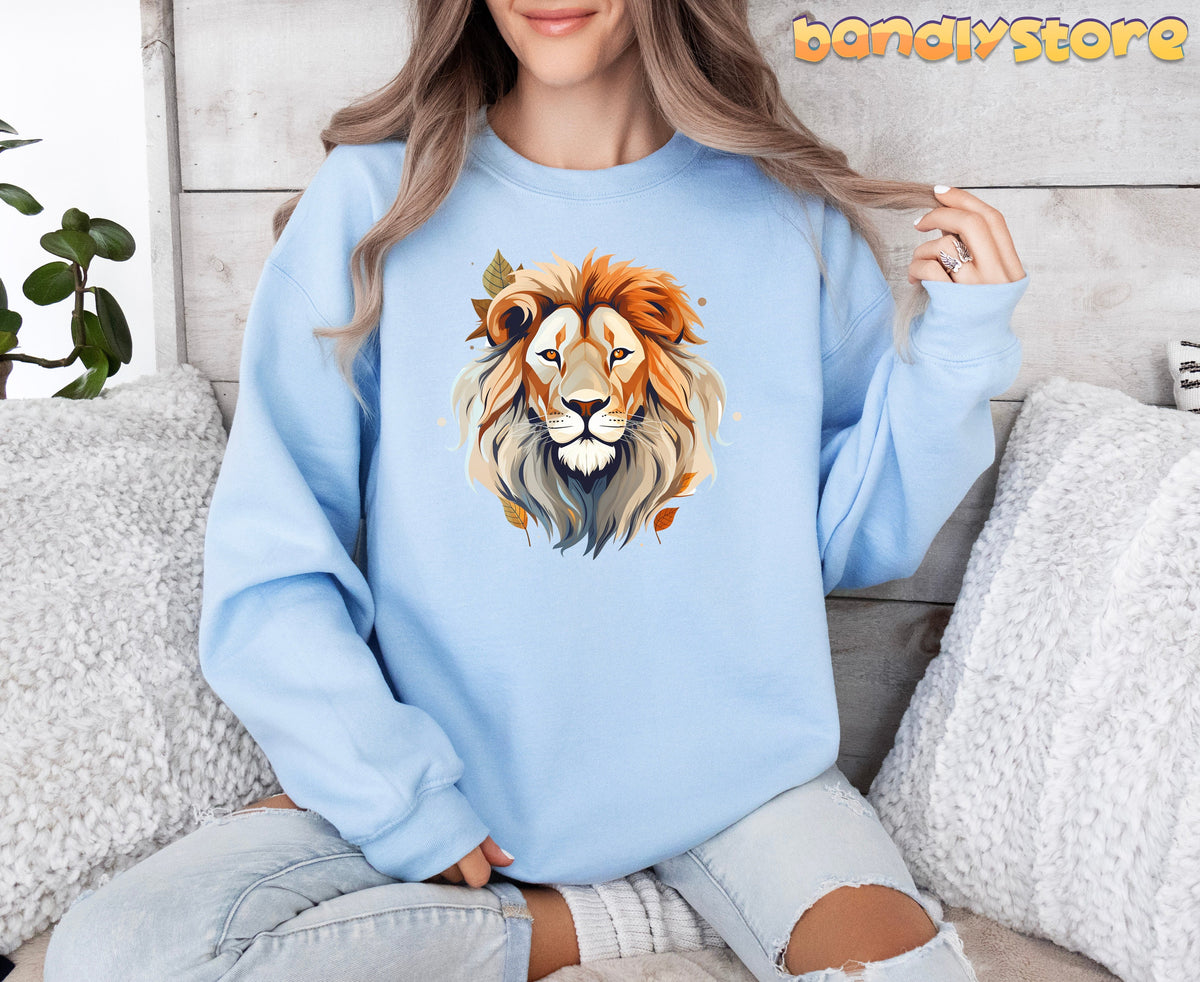 Majestic Lion Sweatshirt light blue on seated woman by wood wall with pillows and plant.