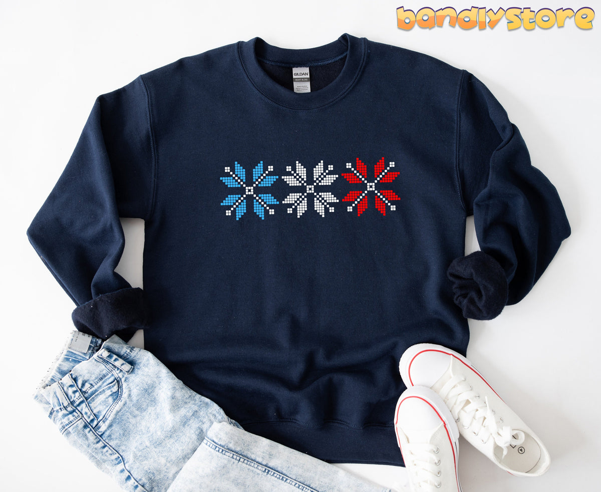 Old Fashioned Snowflake Sweatshirt in navy, laid flat with jeans and white sneakers beside it.