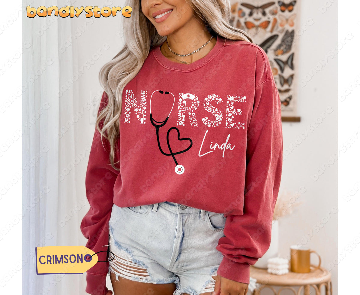 Personalized Nurse Sweatshirt in crimson, front view on a model in a room with butterfly poster and curtains.