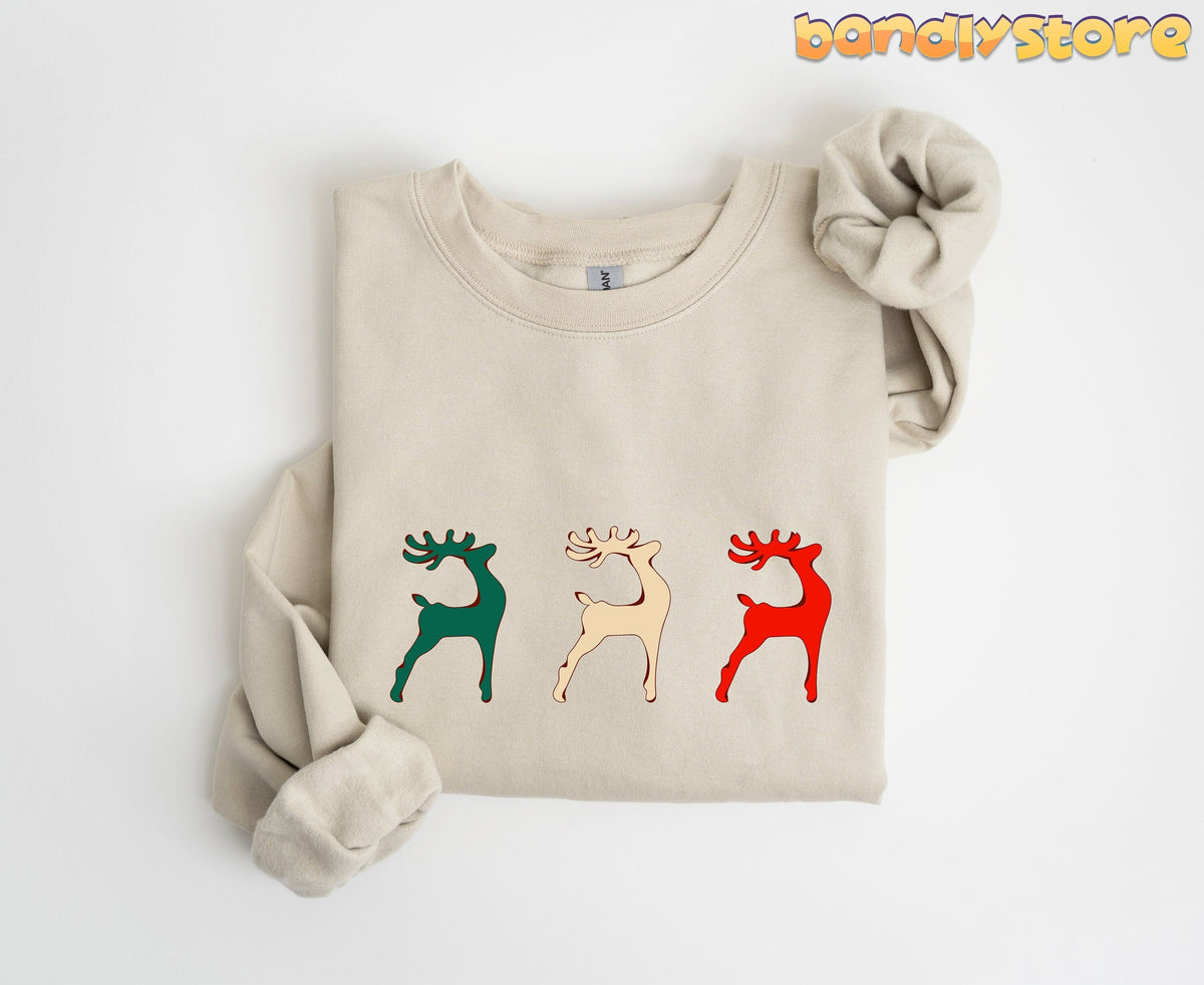 Reindeer Christmas Sweatshirt in sand folded flat on plain white background from above.