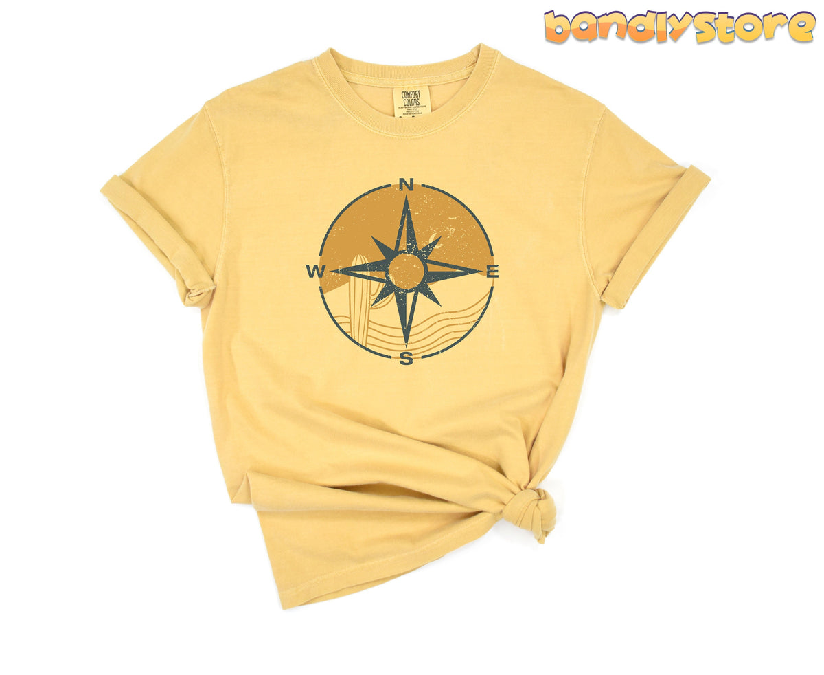 Retro Compass T-Shirt in mustard, front view flat-laid with side knot, plain white backdrop.