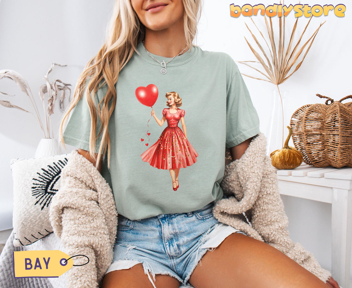 Vintage Valentines Day T-Shirt in Bay on a seated model amid pillows, dried plants, pumpkin and basket.