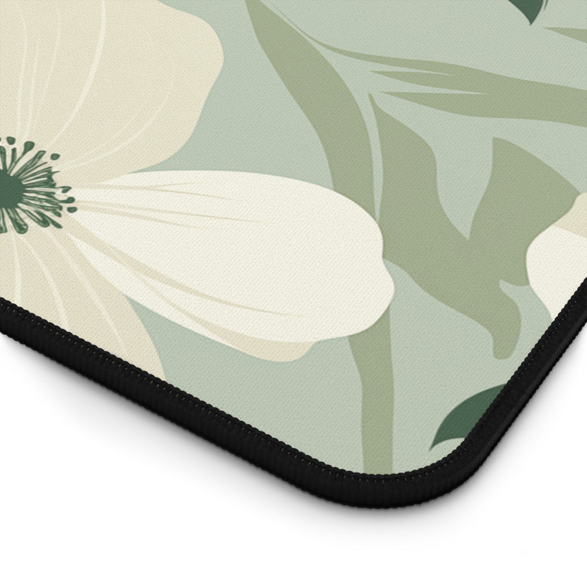 Minimalist Floral Desk Mat close-up of the black stitched corner with floral print.