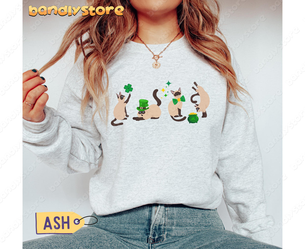 Siamese Cat St Patrick's Day Sweatshirt in ash, worn front-facing with four festive Siamese cats.