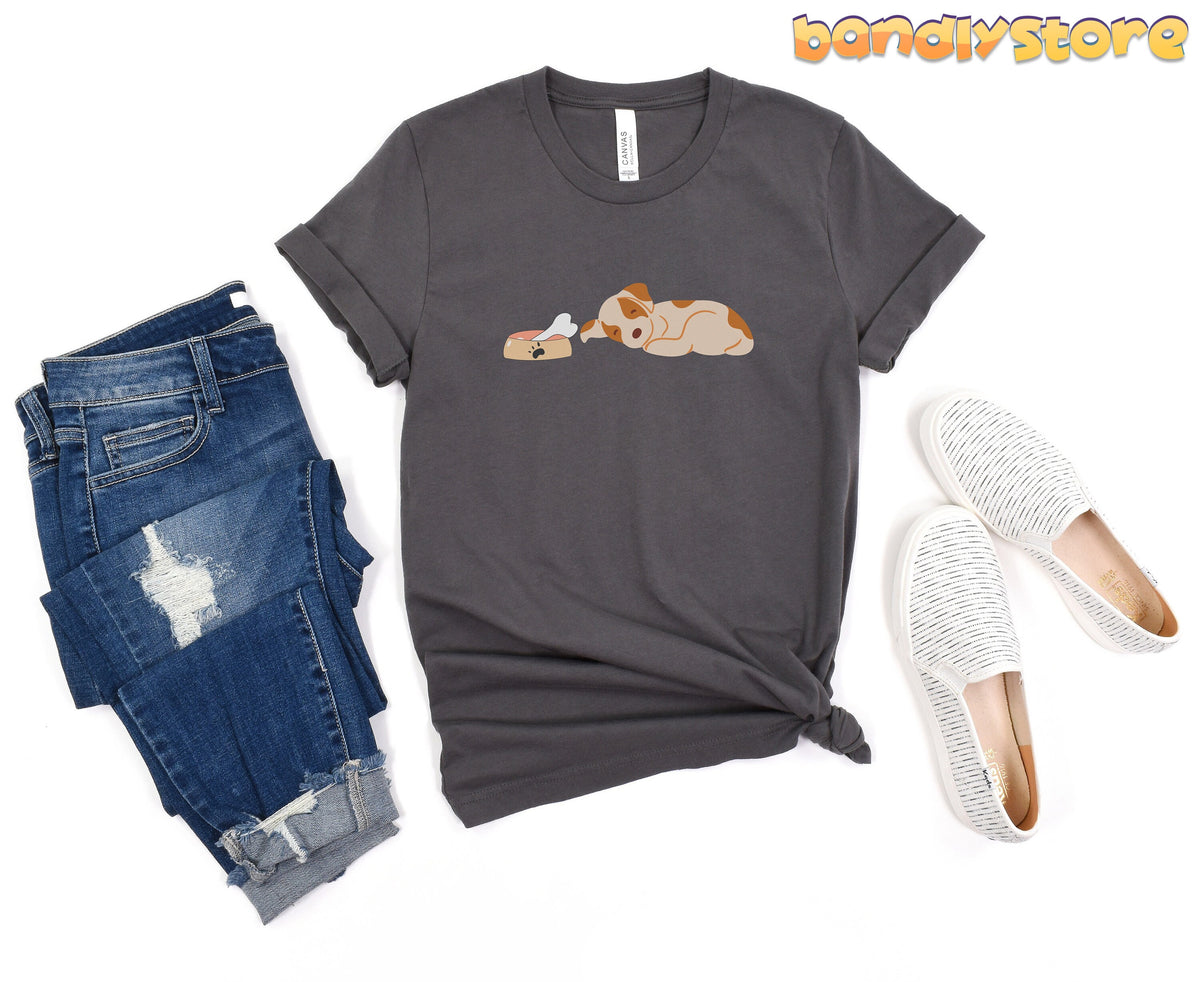 Sleeping Dog T-Shirt in Asphalt laid flat next to ripped jeans and white shoes against a plain background.
