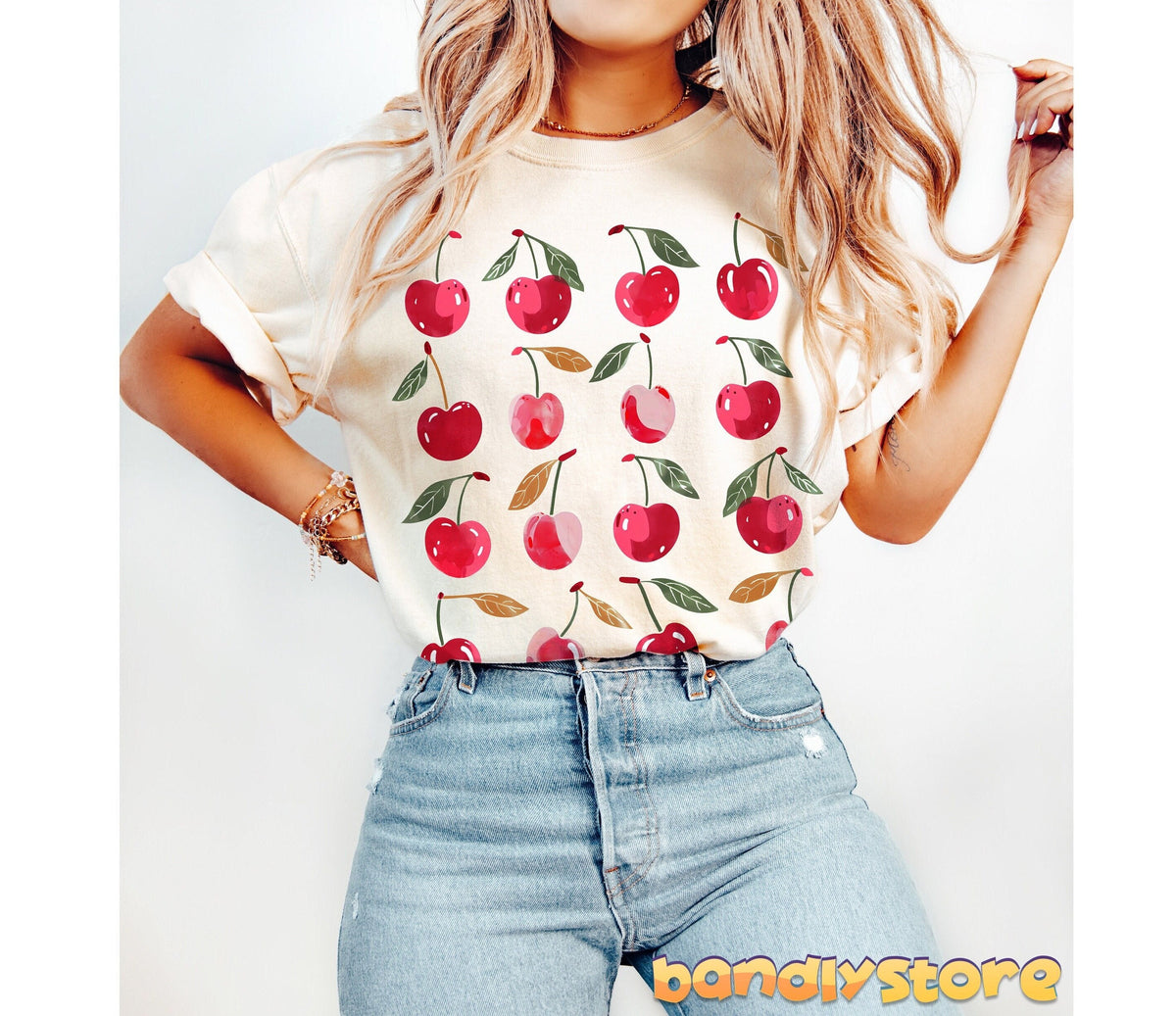 Sweet Cherry T-Shirt in ivory with cherry prints on a model in jeans, front view against plain white background.