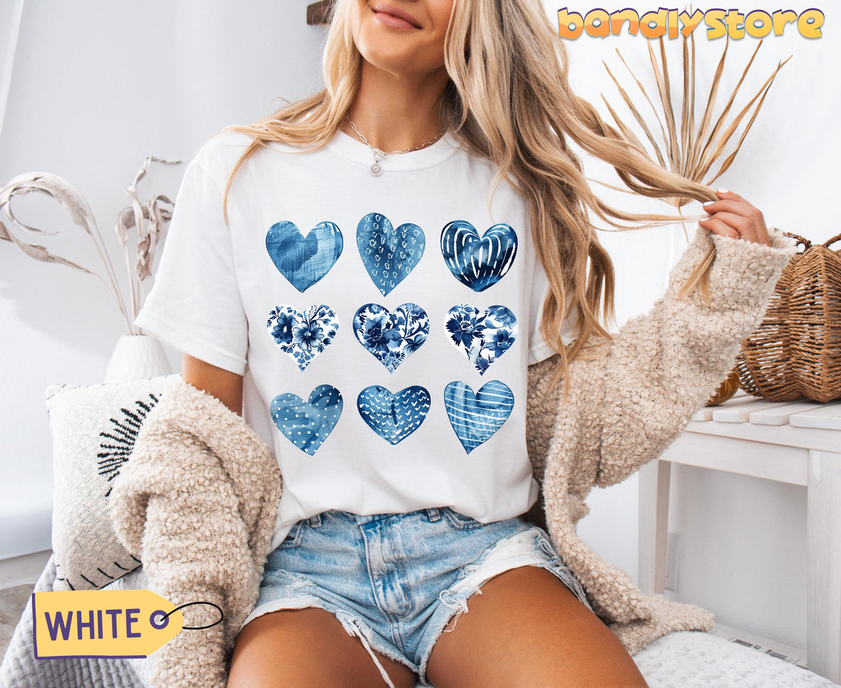 Toile De Jouy Hearts T-Shirt in white on a seated model indoors near dried plants, pillows and a basket.