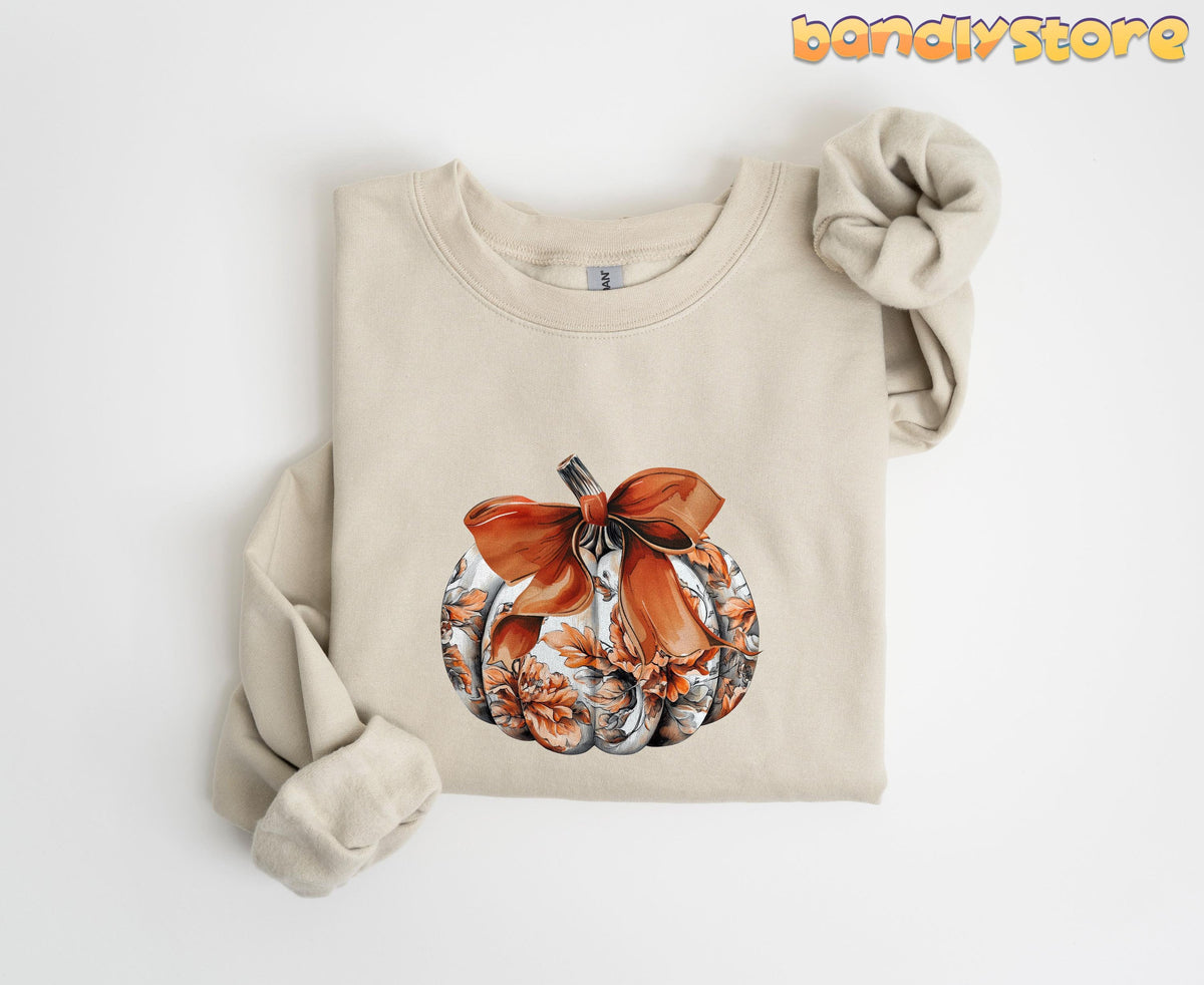 Cute Toile Pumpkin Bow Sweatshirt in sand folded flat on a plain white background.