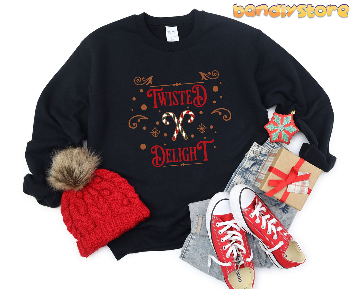 Twisted Delight Candy Cane Sweatshirt in black, flat-laid with red beanie, red sneakers, jeans, gift, and ornament.