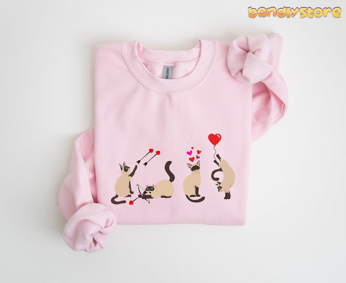 Siamese Cat Valentine Sweatshirt in light pink folded flat on a plain white surface.