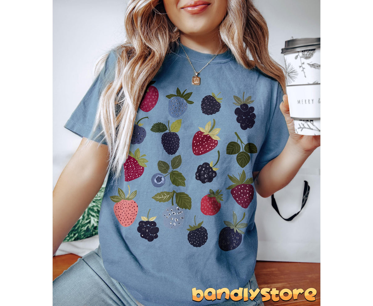Verry Berry T-Shirt in Blue Jean on a person holding a coffee cup, front indoor view.