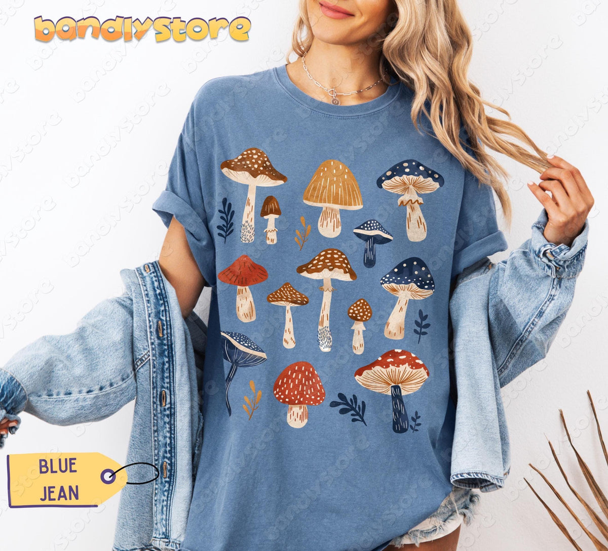 Vintage Mushrooms T-Shirt in Blue Jean on a smiling blonde woman holding a denim jacket against a white backdrop.