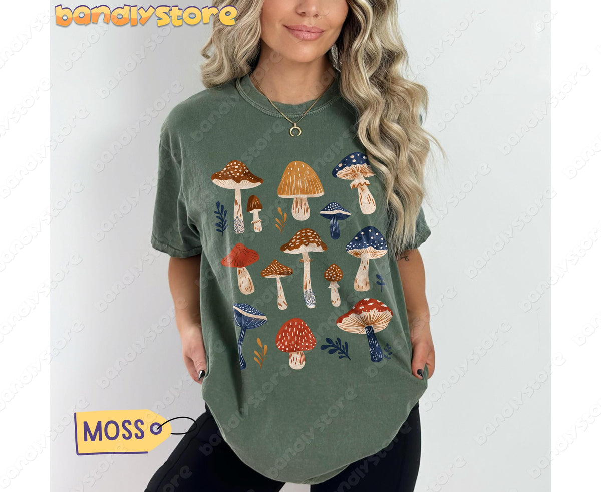 Vintage Mushrooms T-Shirt in Moss, front view on a model with blonde hair standing against a plain white wall.