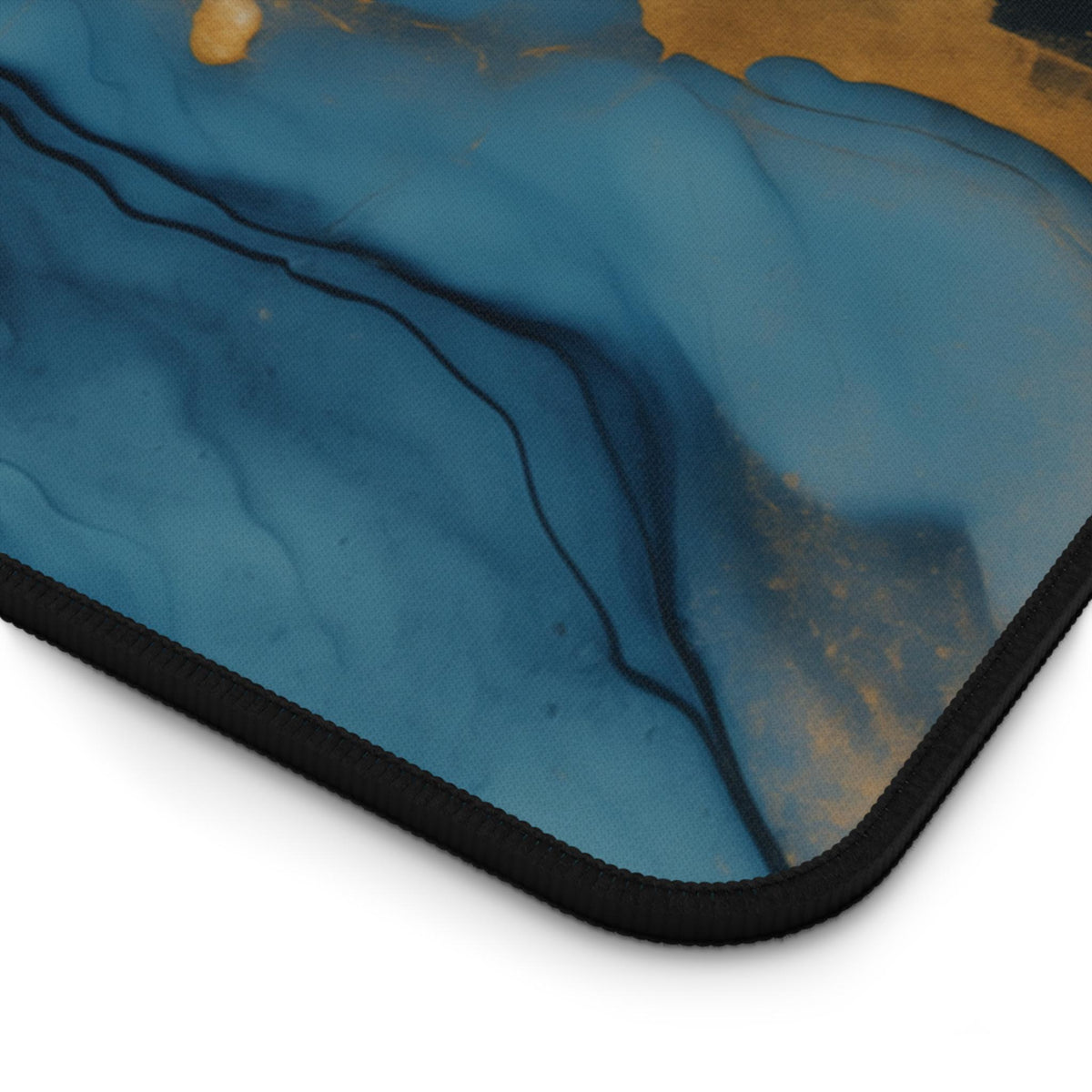Abstract Marble Desk Mat close-up of the curved corner with stitched edge on a plain white background.
