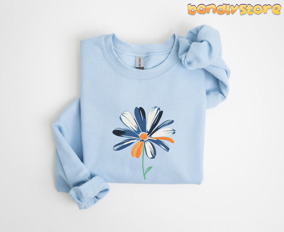 Cute Abstract Daisy Sweatshirt in light blue folded flat on white background from above with knotted sleeve.